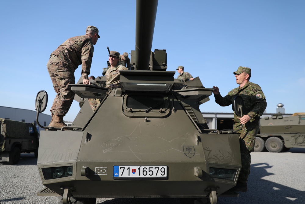 Slovakian NATO EFP soldiers demonstrate equipment to U.S. Soldiers