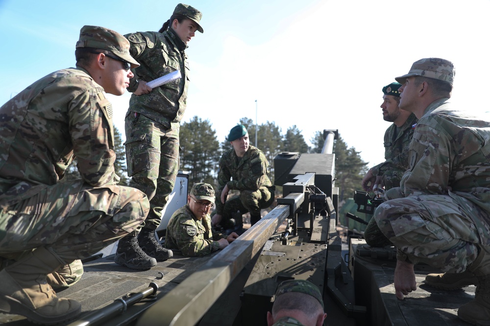 Slovakian NATO EFP soldiers demonstrate equipment to U.S. Soldiers