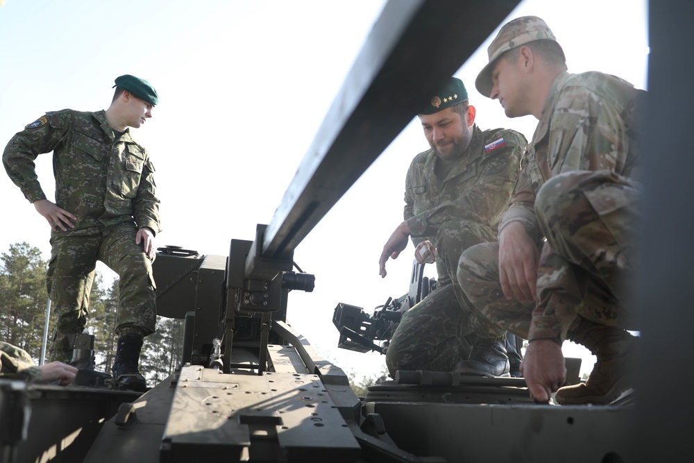 Slovakian NATO EFP soldiers demonstrate equipment to U.S. Soldiers