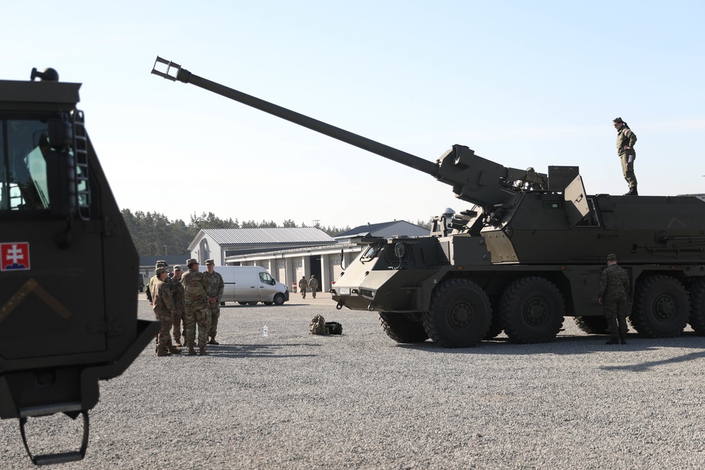 Slovakian NATO EFP soldiers demonstrate equipment to U.S. Soldiers