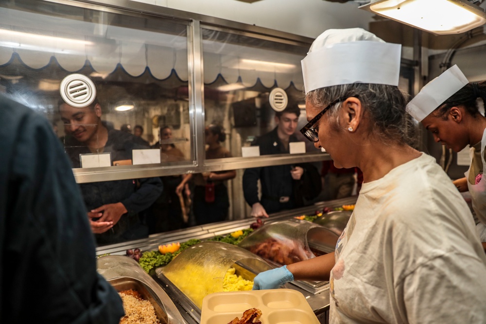 Abraham Lincoln Sailors serve food