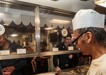 Abraham Lincoln Sailors serve food