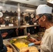 Abraham Lincoln Sailors serve food