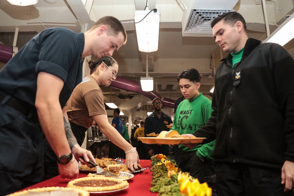 Abraham Lincoln Sailors serve food