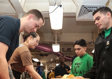 Abraham Lincoln Sailors serve food