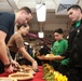 Abraham Lincoln Sailors serve food