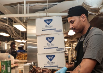 Abraham Lincoln Sailors serve food