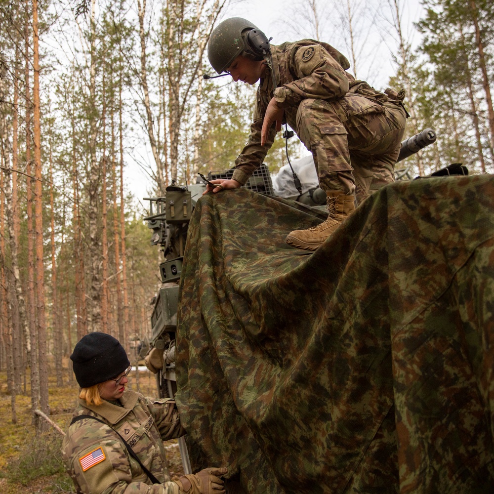 U.S. Army Soldiers camouflage Stryker for Exercise Arrow 22