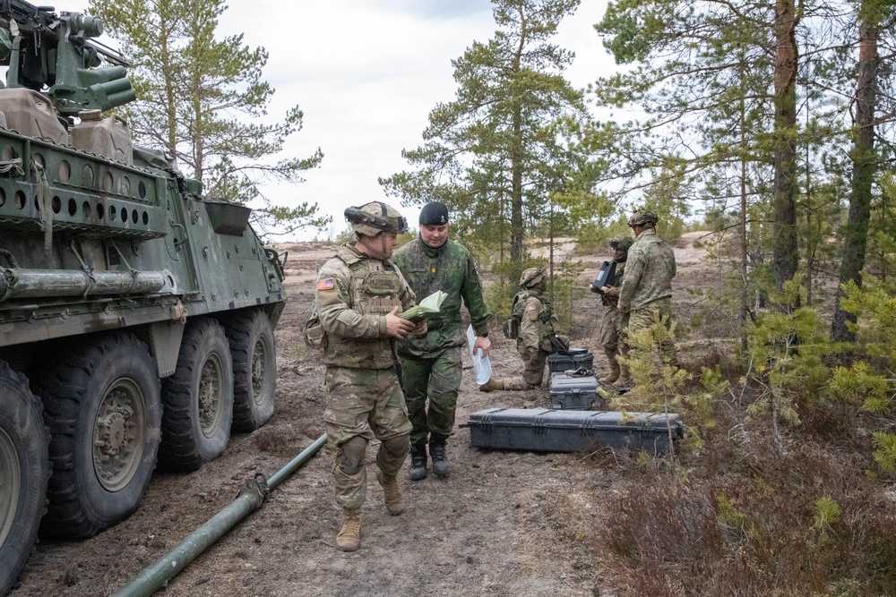 U.S. Army Soldier and Finnish officer inspect equipment at Exercise Arrow 22