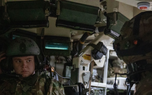 U.S. Army Spc. Caden Sangals listens in on the radio during Exercise Arrow 22