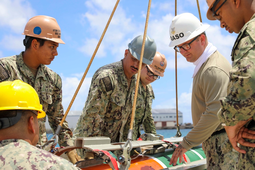 Sailors load mine on USS Annapolis