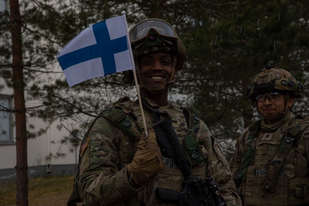 U.S. Army Sgt. waves Finnish flag during Exercise Arrow 22