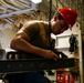 Abraham Lincoln Sailors move ordnance equipment