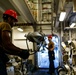 Abraham Lincoln Sailors move ordnance equipment