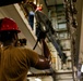 Abraham Lincoln Sailors move ordnance equipment