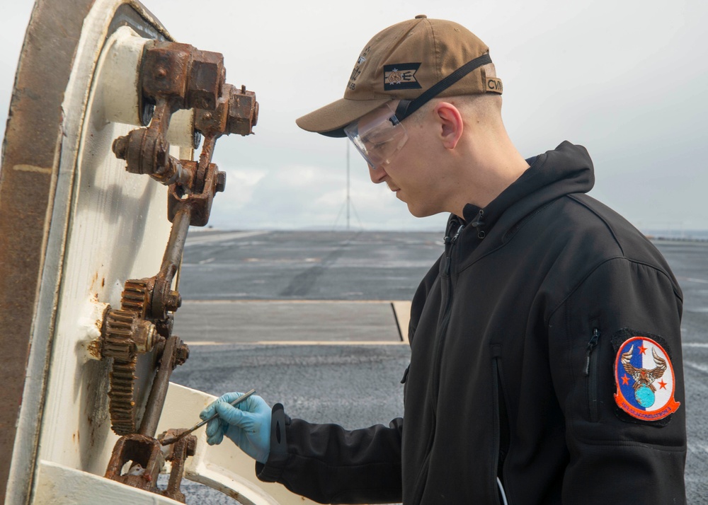 Sailor Conducts Maintenance On The Flight Deck