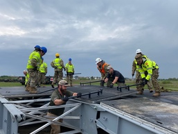 21st TSC Soldiers receive instruction on a RAIL prototype with Latvian Soldiers