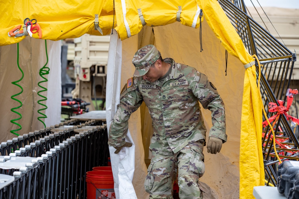 Engaged Squad Leader Conducts Inspections of Decontamination Line