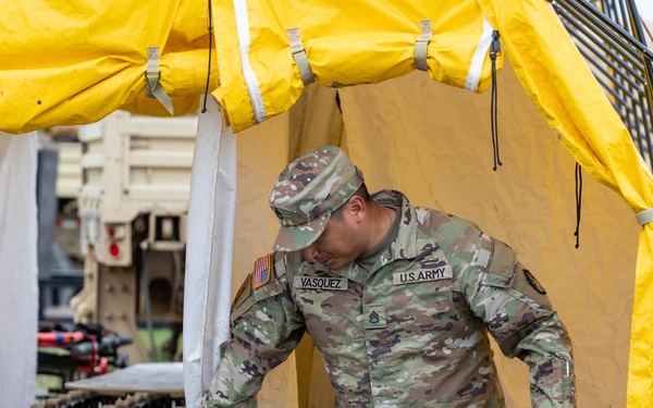 Engaged Squad Leader Conducts Inspections of Decontamination Line