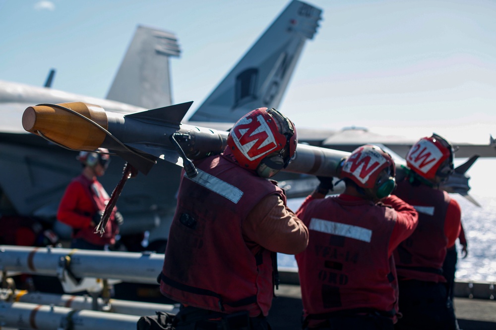 Abraham Lincoln Sailors load ordnance