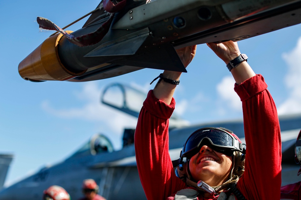 Abraham Lincoln Sailors load ordnance