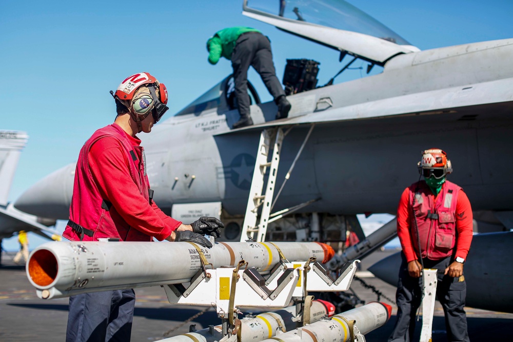 Abraham Lincoln Sailors load ordnance