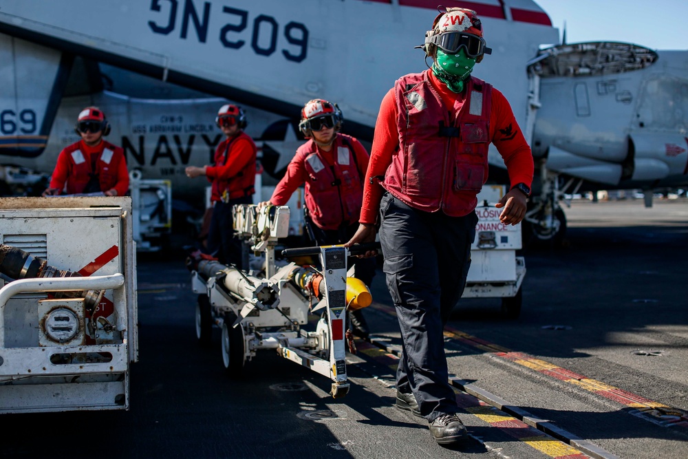 Abraham Lincoln Sailors load ordnance