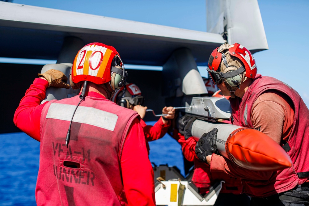 Abraham Lincoln Sailors load ordnance