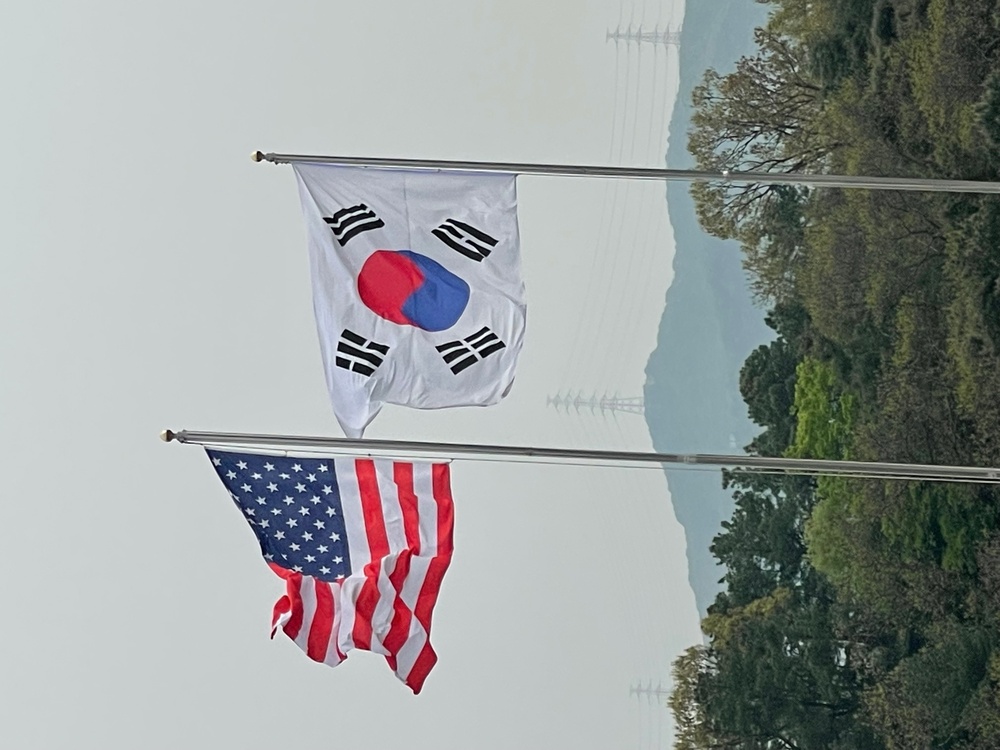 U.S. flies over South Korea next to their flag