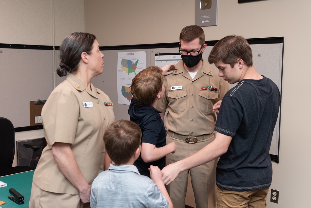 Master Chief Musician Adam Grimm, Navy Band Public Affairs Officer, is pinned to E9