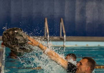 Staff Sgt. Amick Philip tosses his uniform top