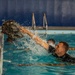 Staff Sgt. Amick Philip tosses his uniform top
