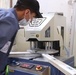 PVC trainee welds a door frame in USAID-supported vocational training course.