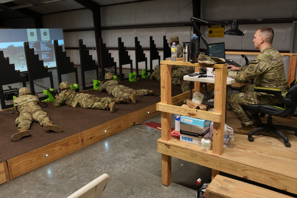 Louisiana National Guard Staff Sgt. Lawrence Varnado with 1-244th Assault Battalion runs an Engagement Skills Trainer for Soldiers from the Virgin Islands during annual training at Camp Shelby, Mississippi, May 16, 2022.