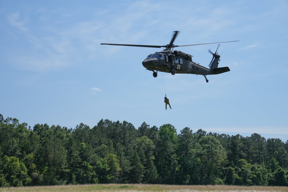 Louisiana National Guard Soldiers with 204th Theater Airfield Operations train on hoist operations with Black Hawks during annual training at Camp Shelby, Mississippi, May 16, 2022.