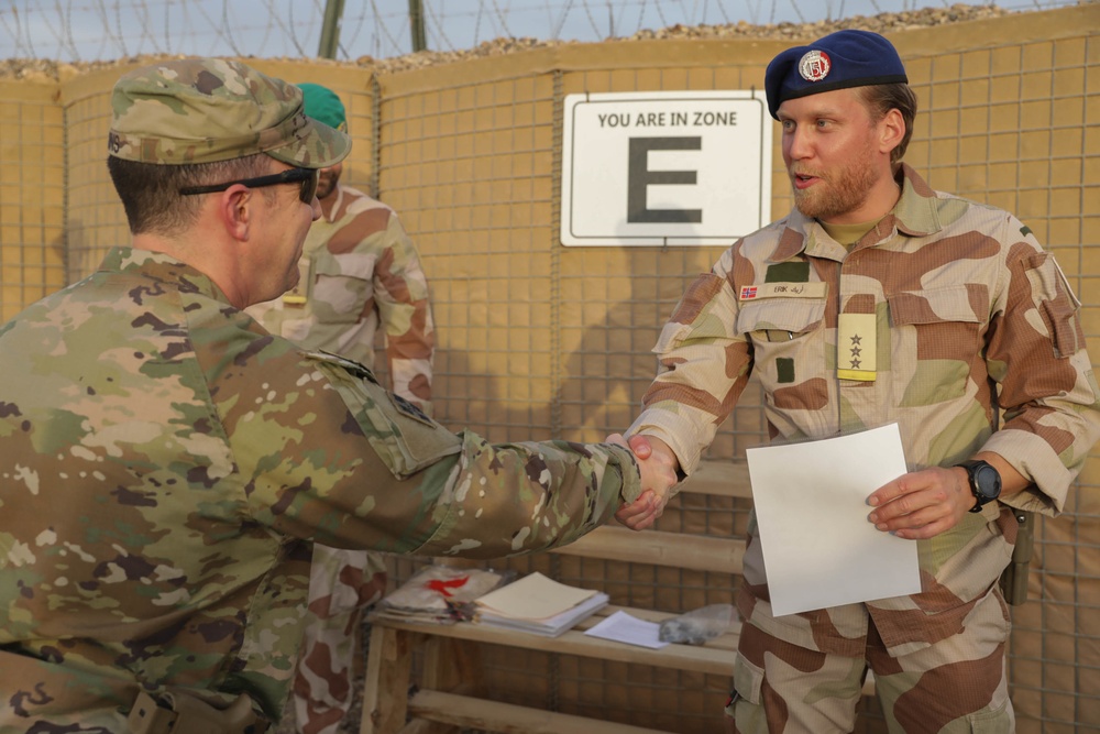 U.S. Soldiers and Coalition partners conduct Norwegian Ruck March at Al Asad Air Base, Iraq