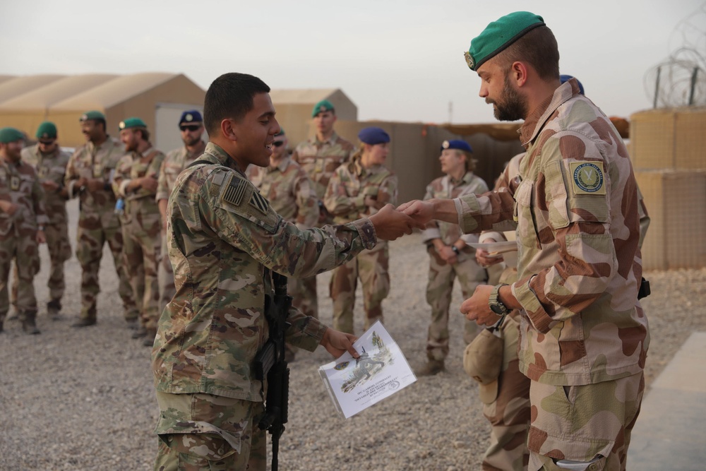 U.S. Soldiers and Coalition partners conduct Norwegian Ruck March at Al Asad Air Base, Iraq