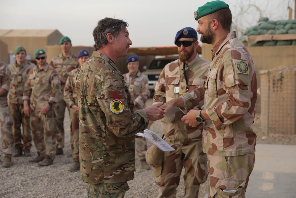 U.S. Soldiers and Coalition partners conduct Norwegian Ruck March at Al Asad Air Base, Iraq