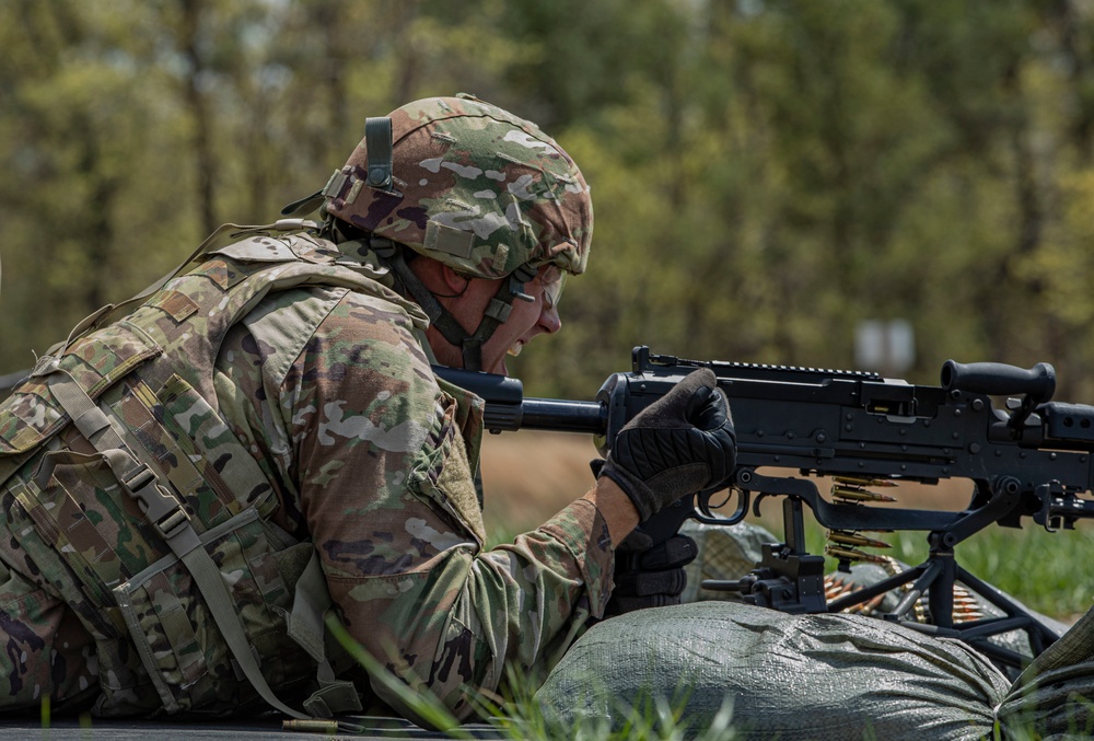 Army Reserve Spc. Doles Thomas pulls the charging handle