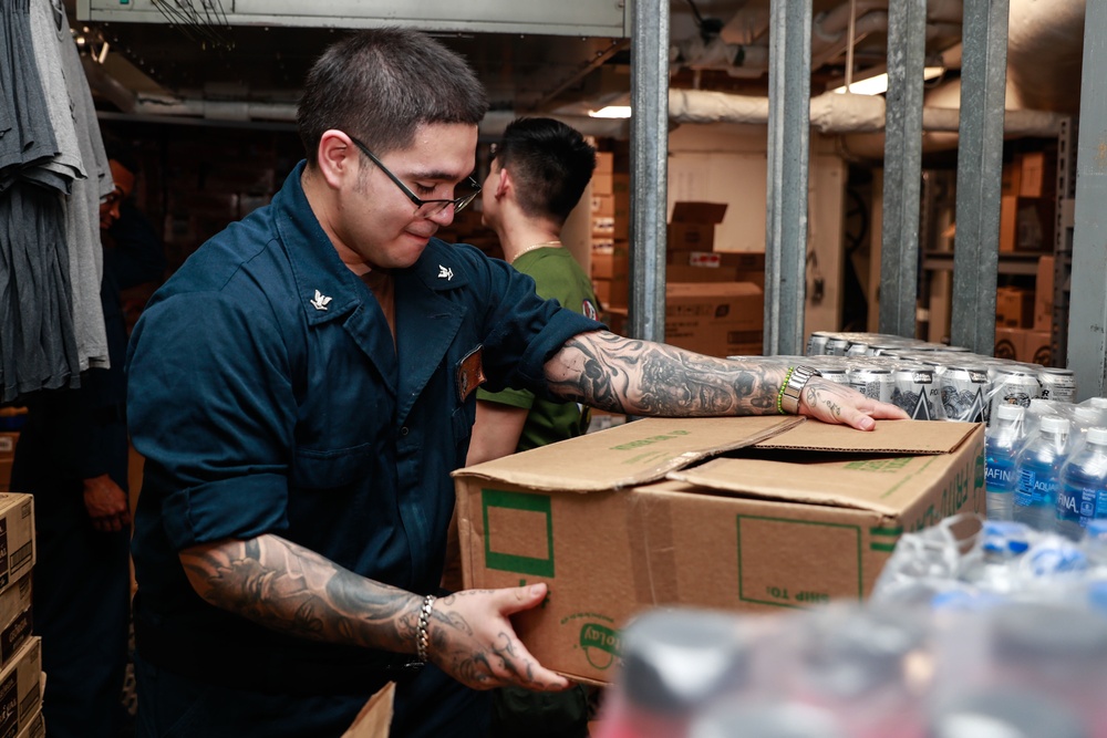 Abraham Lincoln Sailors restock ship's store