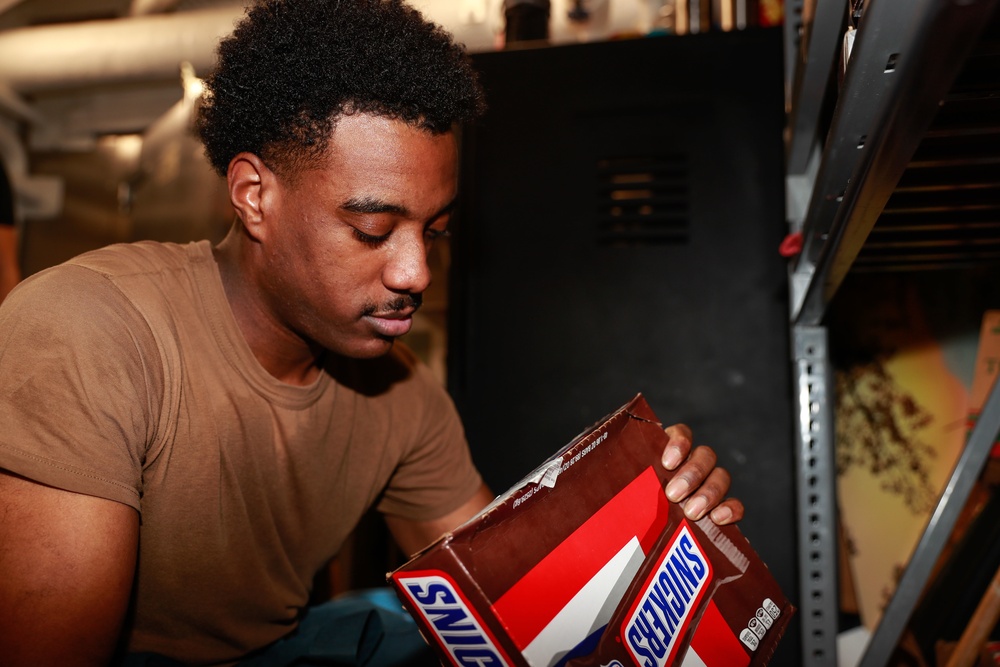 Abraham Lincoln Sailors restock ship's store