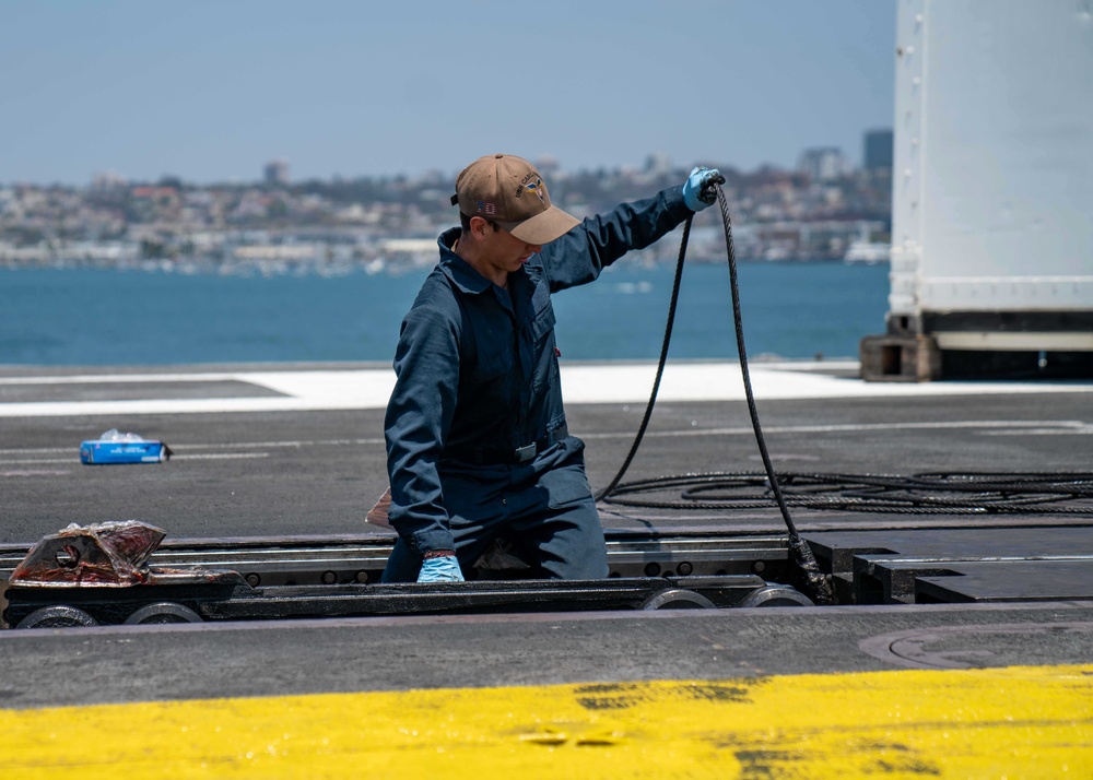 USS Carl Vinson (CVN 70) Sailor Removes Aircraft Catapult Wire