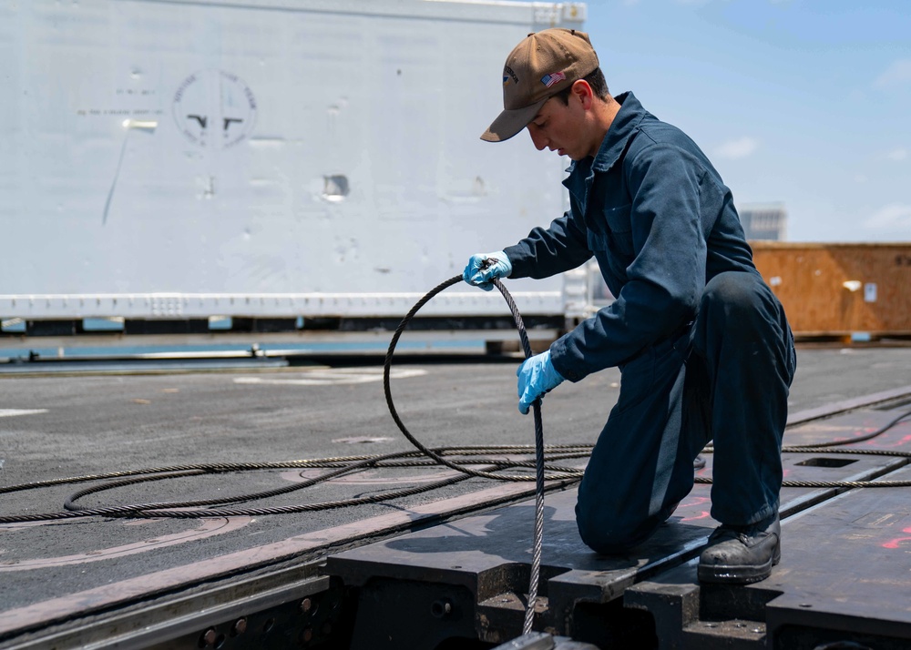 USS Carl Vinson (CVN 70) Sailor Removes Aircraft Catapult Wire