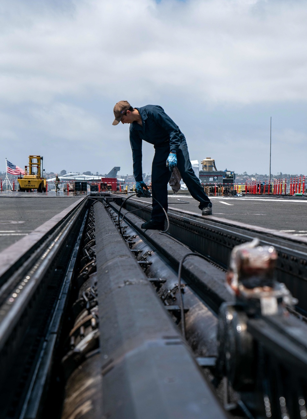 USS Carl Vinson (CVN70) Sailor Removes Aircraft Catapult Wire