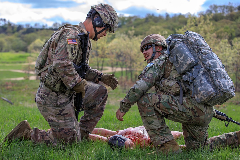 Sgt. Tyler Bennett helps Sgt. Joshua Albrecht asses a casualty