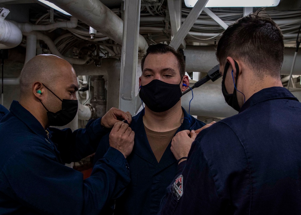 Gridley conducts a promotion ceremony in a main engine room