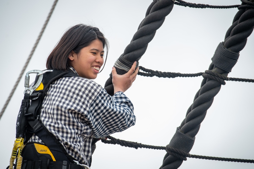 Sailor climbs the shroud