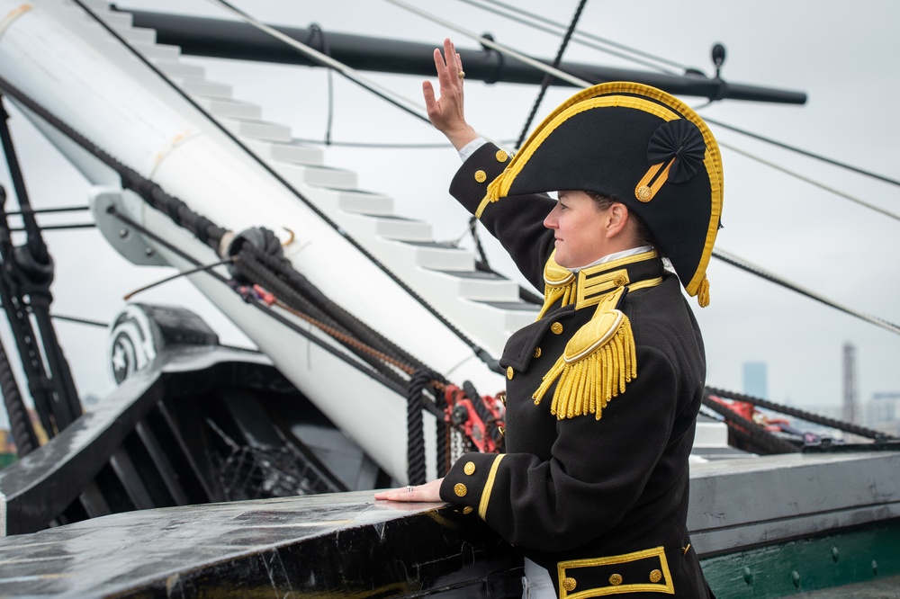 Commanding Officer waves after a 21-gun salute