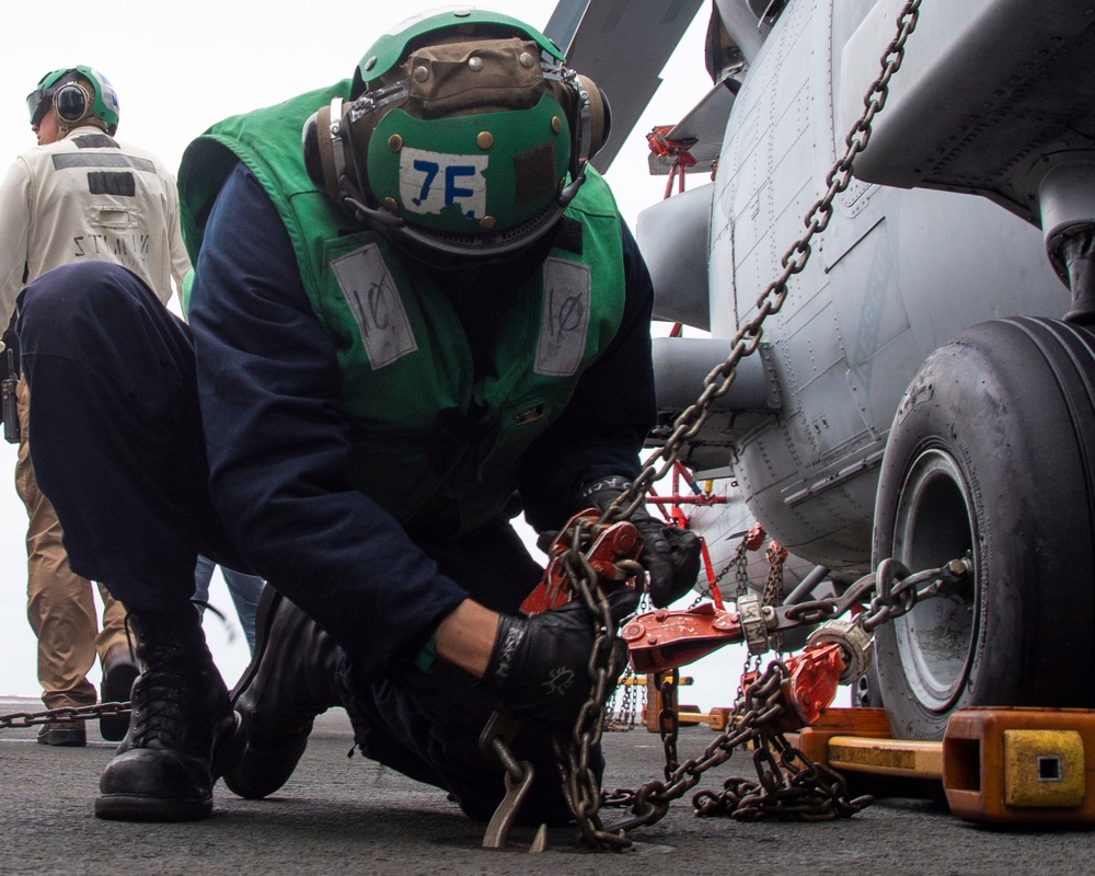 Sailor Chains Down An MH-60S Sea Hawk