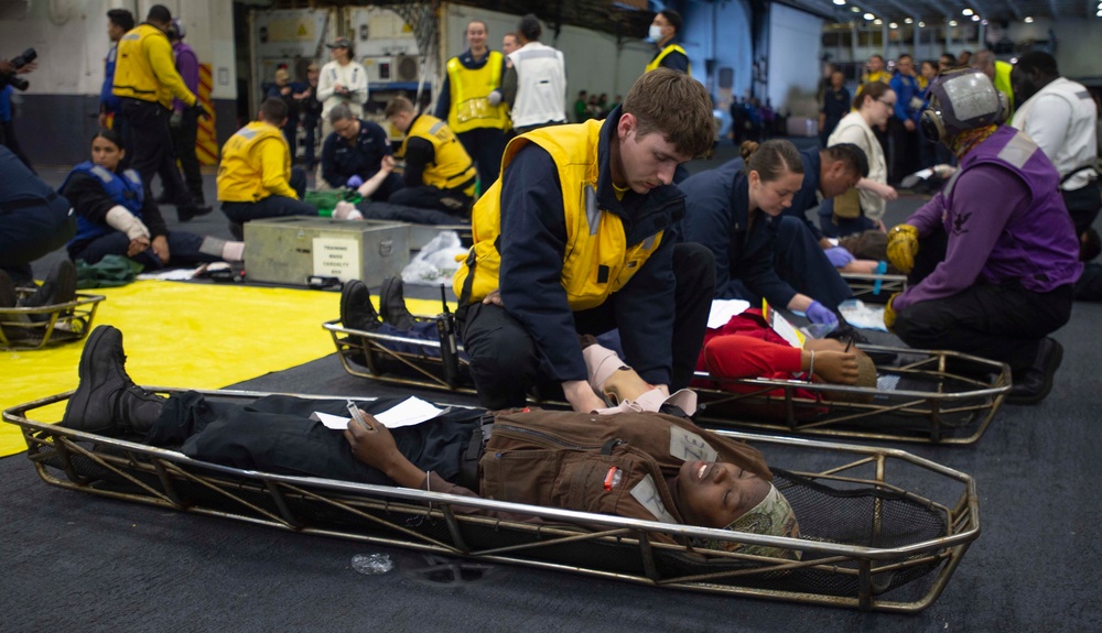 Sailor Applies A Wrap To Arm Of Casualty